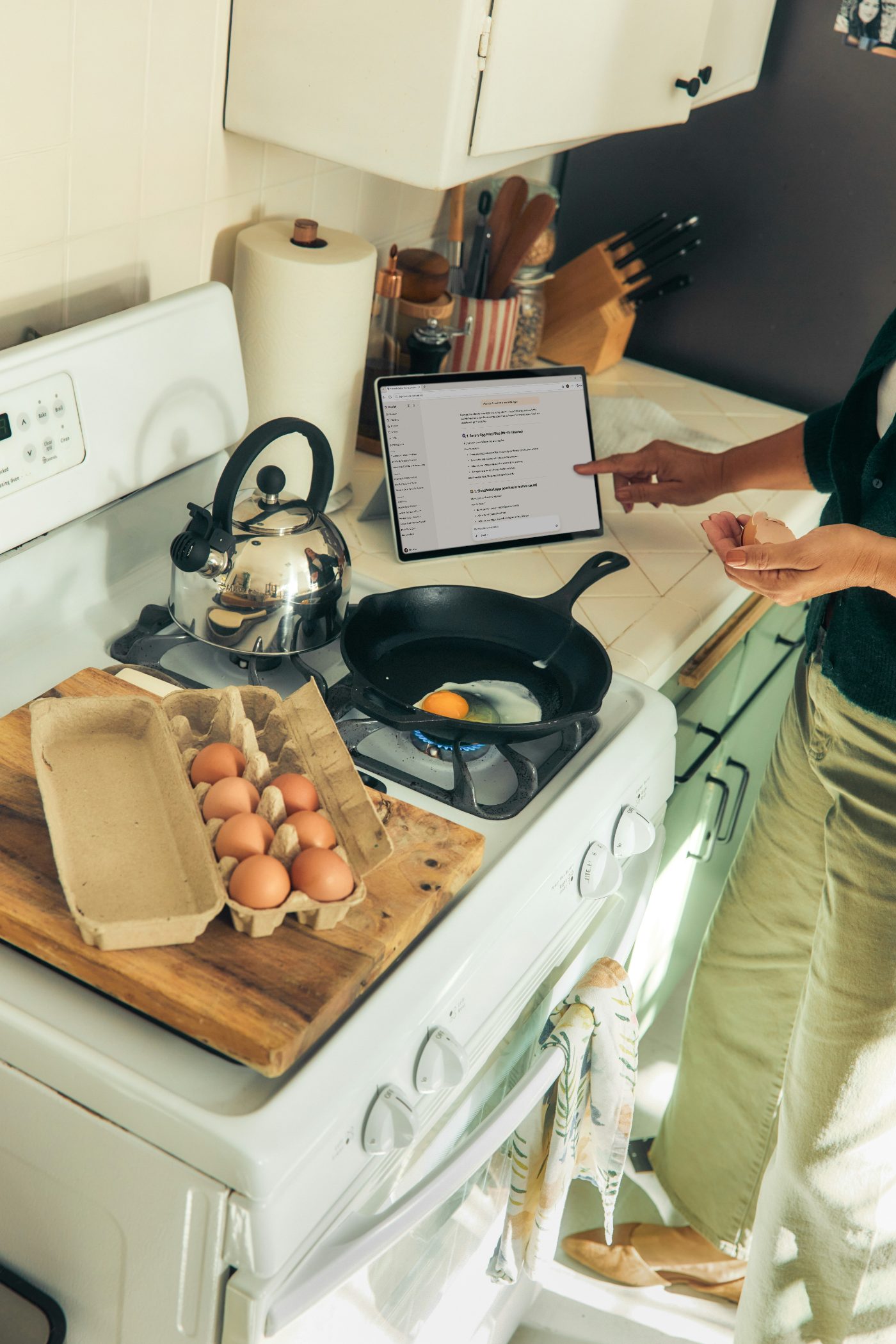A bright kitchen where a host prepares breakfast.