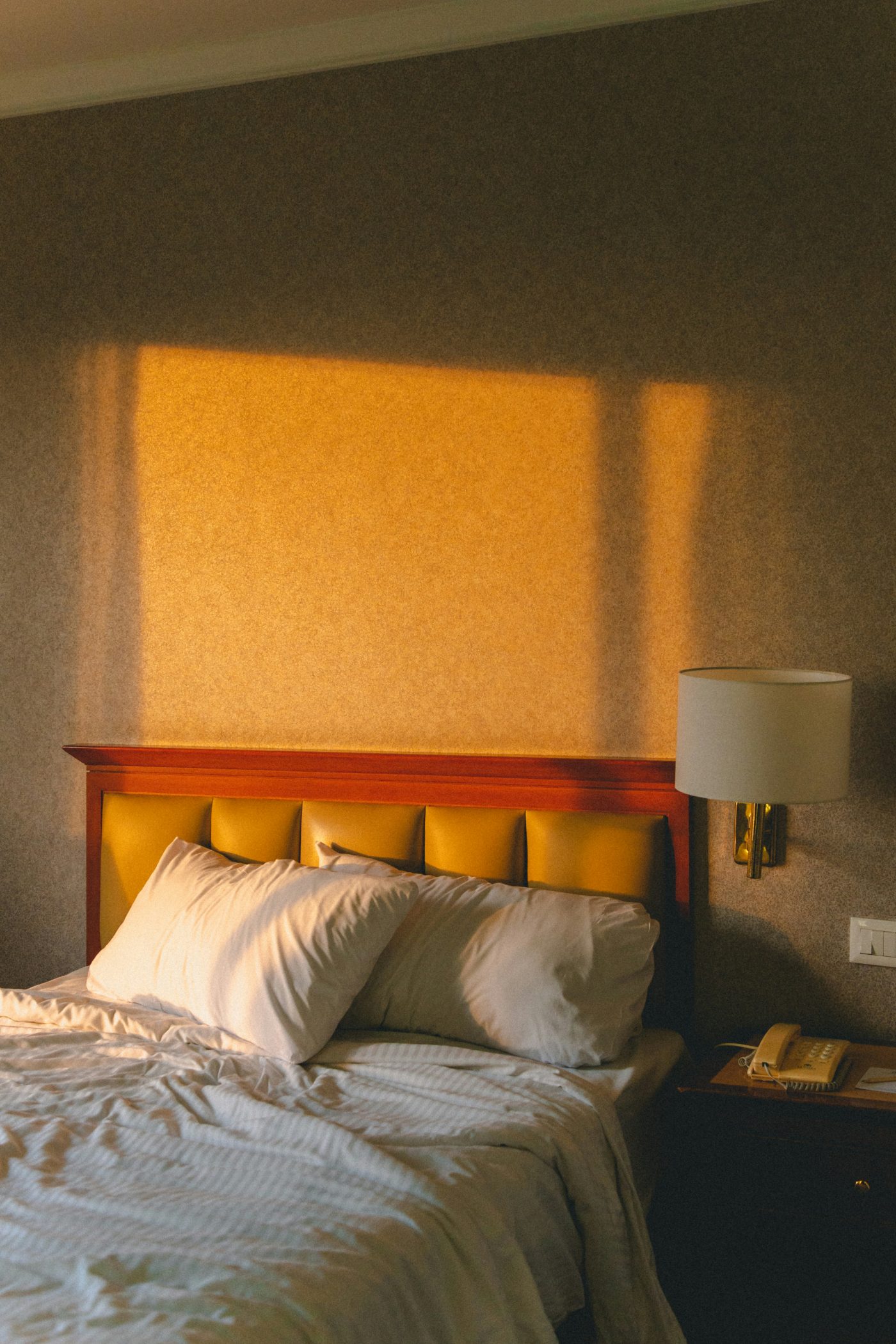 A warm bedroom bathed in golden late-afternoon light.