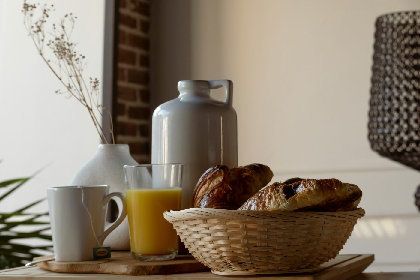 A welcome breakfast of croissants, juice and coffee on a tray.