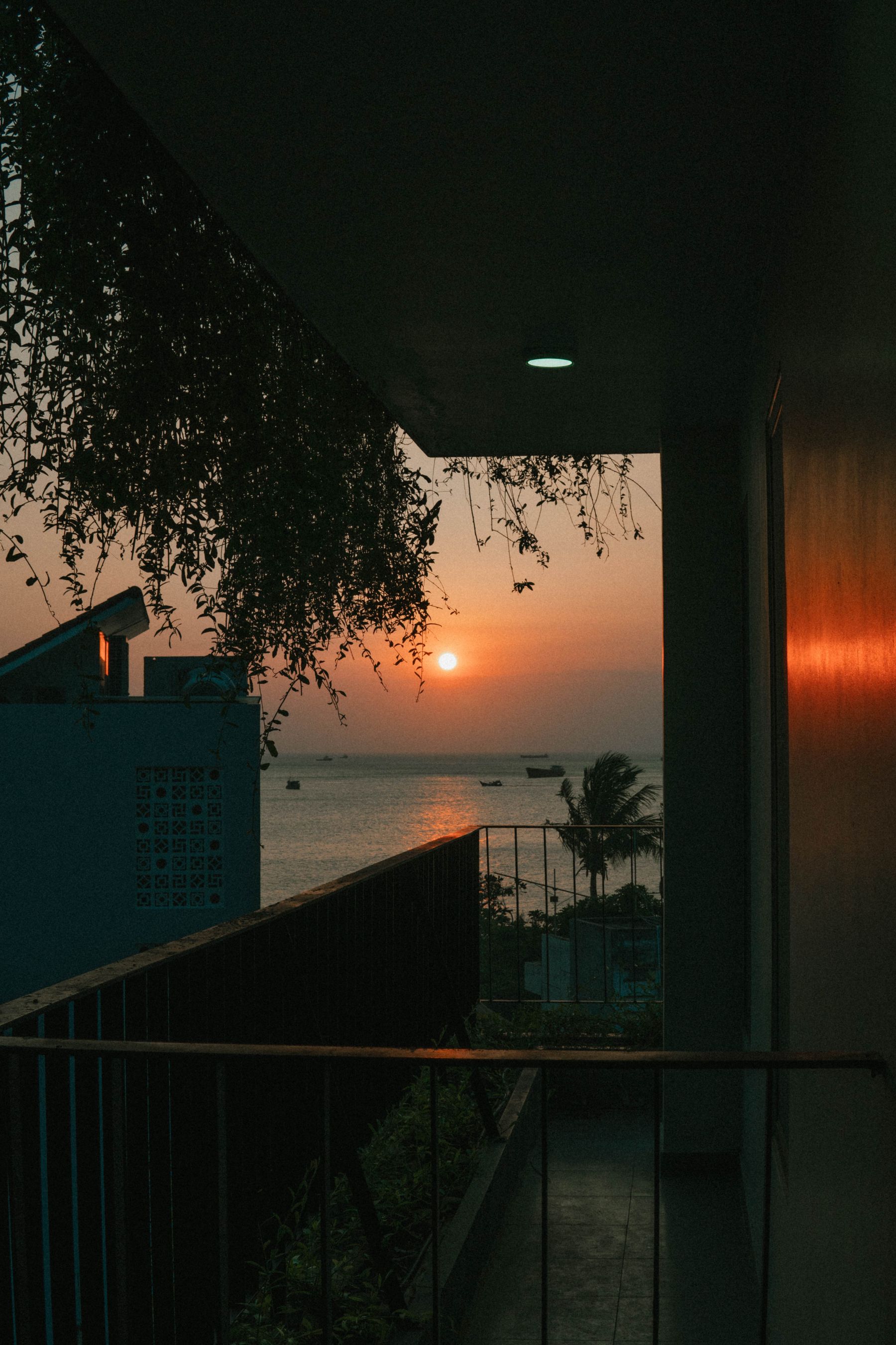 A sunny balcony with lounge seating overlooking the water.